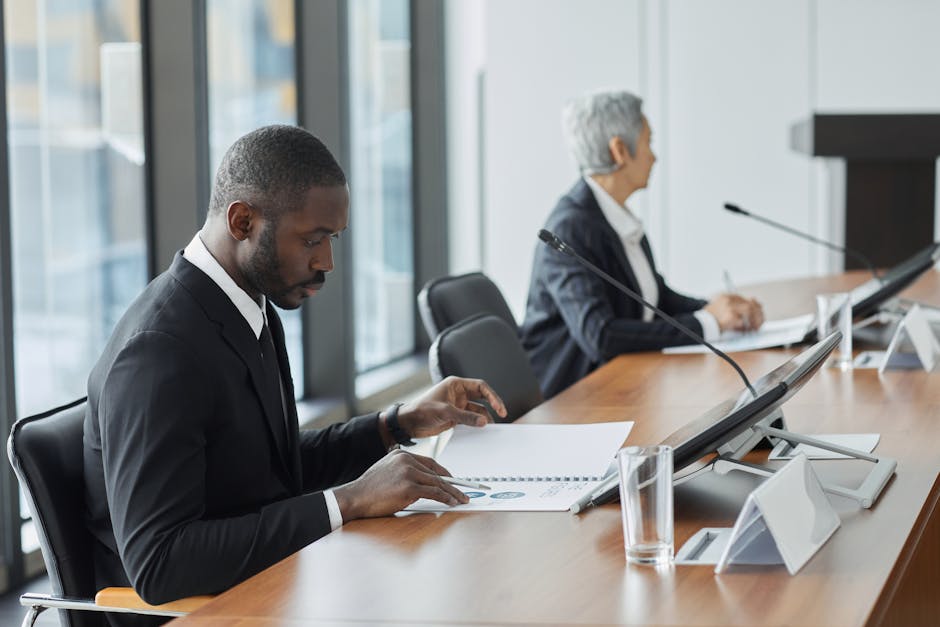 A diverse team of professionals engages in a conference room meeting.